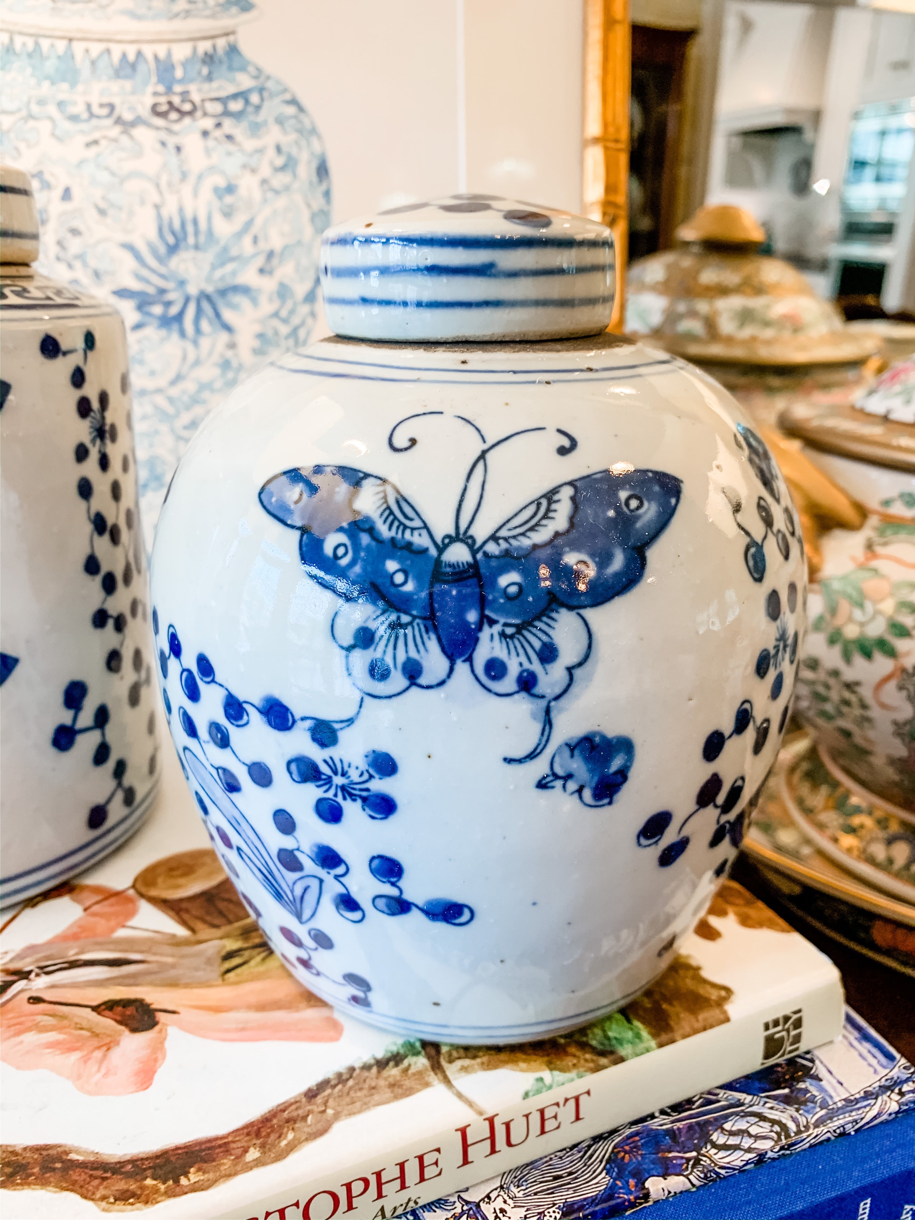 Shop Collectible Brooks for a wide selection of classic blue and white ginger jars, perfect for adding a touch of chinoiserie to your home decor!  This is a beautiful blue and white ginger jar featuring a butterfly design and measuring 5.5"x7.5".