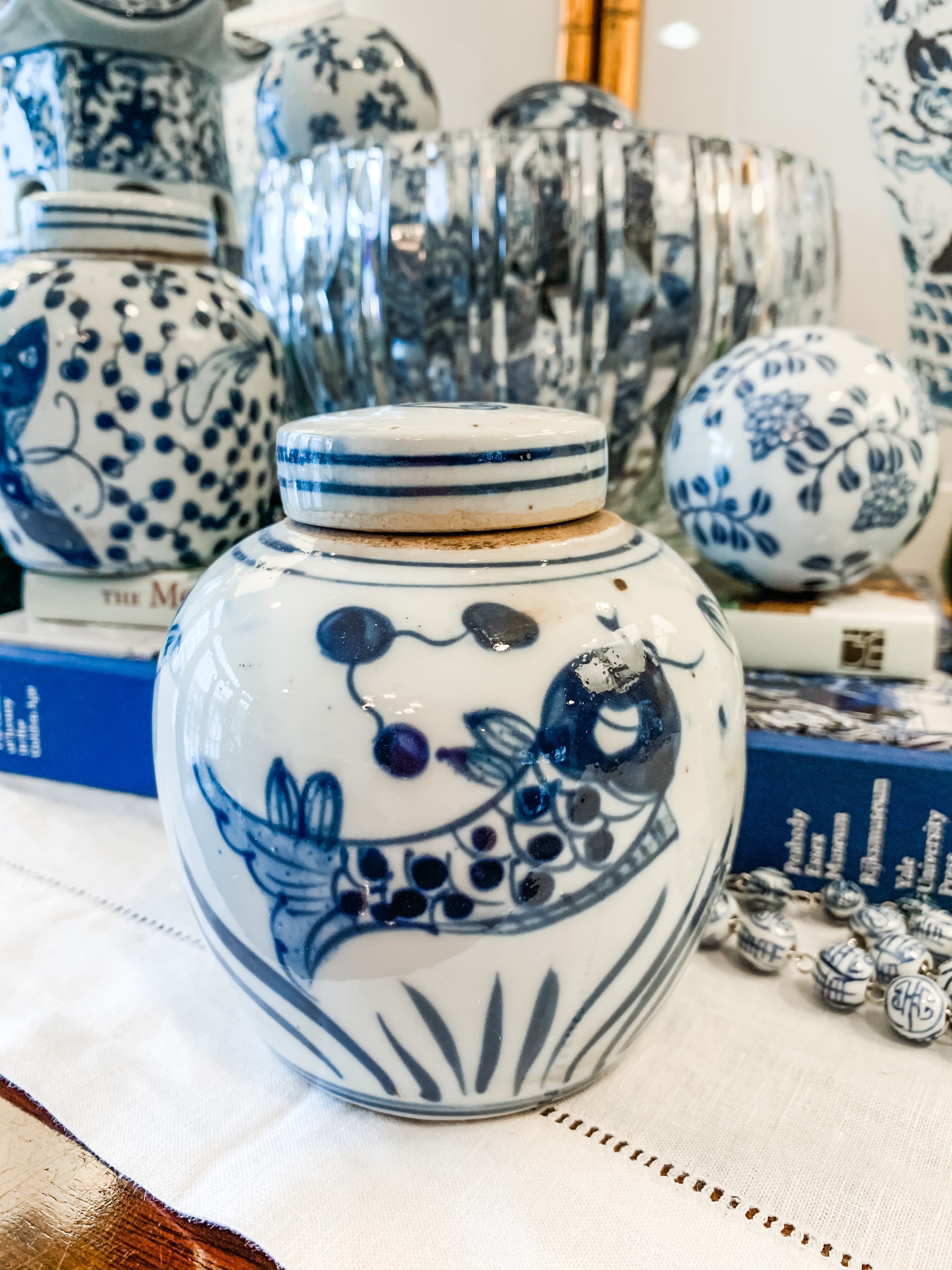 Shop Collectible Brooks for a wide selection of classic blue and white ginger jars, perfect for adding a touch of chinoiserie to your home decor!  This beautiful hand painted ginger jar made in antique style features a fish design and a stands 4.5" tall. 