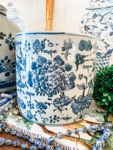 Shop Collectible Brooks for a wide variety of blue and white chinoiserie porcelain.  This is the perfect sized blue and white porcelain cache pot or planter for an orchid, your kitchen utensils, and even a wine chiller! Measures 7.5”x7.5”, hand painted with a peony and lotus design and is in new antique-style condition.